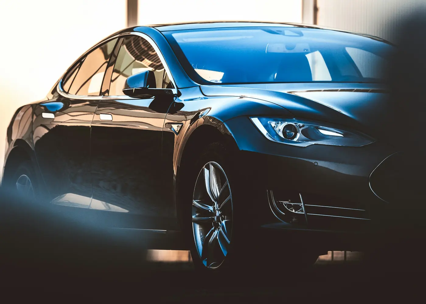A dark blue electric sedan, front three-quarter view