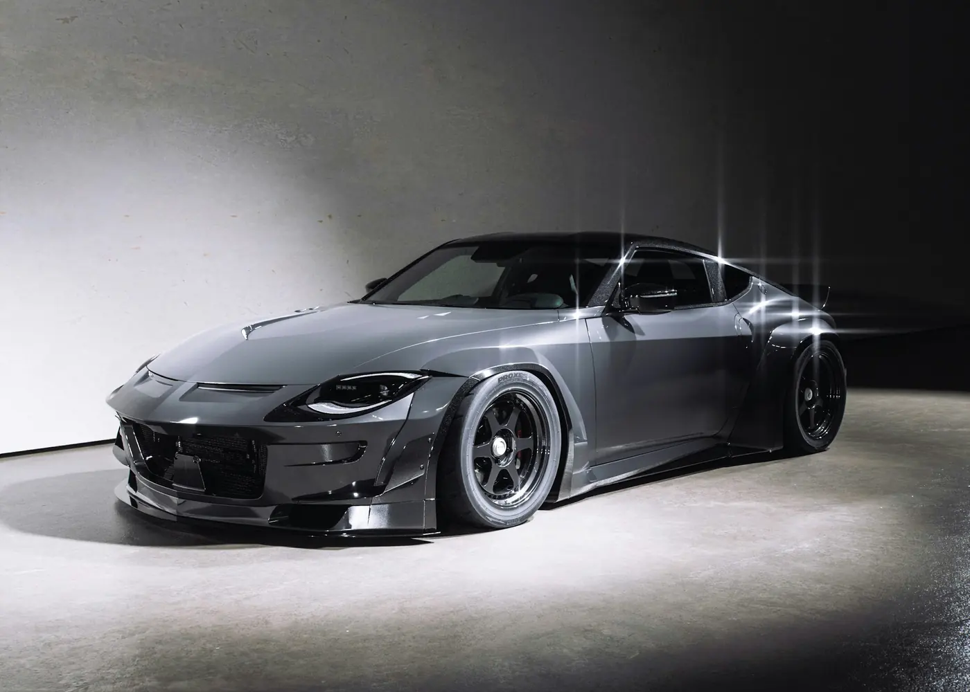 A grey performance car under studio light